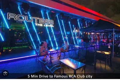 a group of people sitting at tables in a nightclub at Near Big Jodd Fair Night Market and Shopping Mall in Bangkok