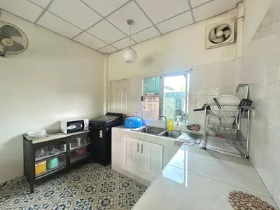 a kitchen with a sink and a counter top at J House in Nonthaburi