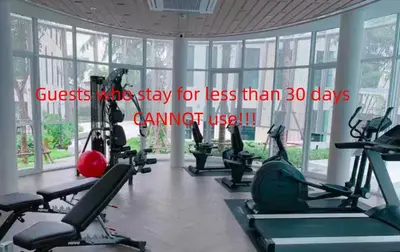 a gym with treadmills and elliptical machines at Sunlit Nest Sukhumvit in Ban Khlong Samrong