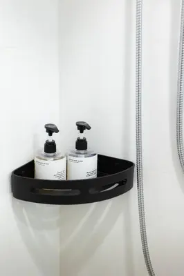 a shelf in a bathroom with three toiletries at Peaceful Townhouse in Sathorn Near Saint Louis BTS in Yan Nawa