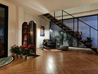a living room with a staircase in a house at Thonglor 4-story modern art villa Free WiFi Netflix in Bangkok