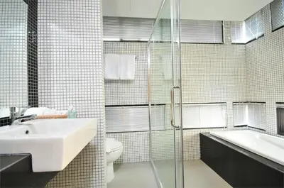 a bathroom with a sink and a toilet and a shower at Premier Place Bangkok in Bangkok