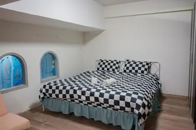 a bedroom with a black and white checkered bed at Skutan-MTB Bangchak in Bangkok