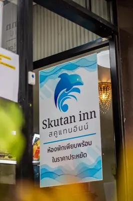 a sign on a window of a restaurant with a wave at Skutan-MTB Bangchak in Bangkok