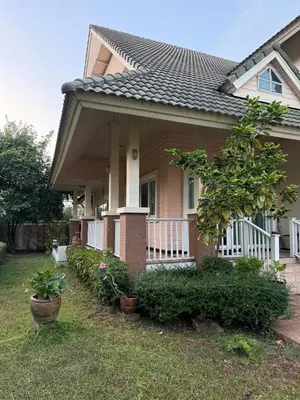 a house with a porch with a fence and plants at Family home Don muang airport in Lak Si