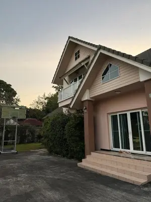 a house with a balcony on the side of it at Family home Don muang airport in Lak Si