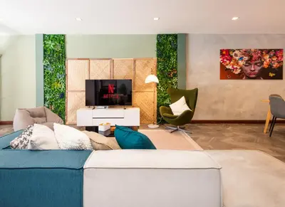 a living room with a couch and a tv at 3BR design townhouse in central Bangkok - 10min to BTS, Emquartier in Bangkok