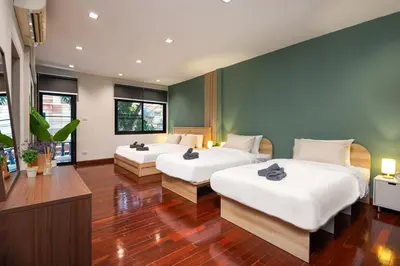 two beds in a room with two windows at 3BR design townhouse in central Bangkok - 10min to BTS, Emquartier in Bangkok