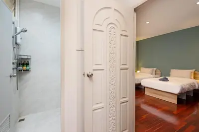 a door leading to a bedroom with a bed at 3BR design townhouse in central Bangkok - 10min to BTS, Emquartier in Bangkok