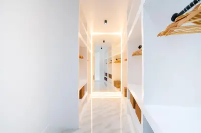a hallway of a house with white walls and a glass wall at Bangkok Luxury Private Pool & Jacuzzi Villa , Daily Maid in Bang Bua Thong