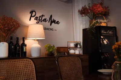 a dining room with a table with bottles of wine at Baan K Residence in Bangkok