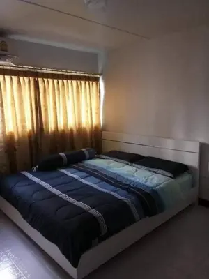 a large bed in a bedroom with a window at Popular Condo เมืองทองธานี in Thung Si Kan