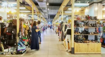 a group of people standing in a store aisle at Popular Condo เมืองทองธานี in Thung Si Kan