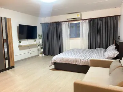 a hotel room with a bed and a couch at T12 Popular Condo By hunnity 2 in Ban Bang Phang