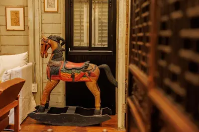 a statue of a horse standing in front of a door at The Anonymous House in Bangkok