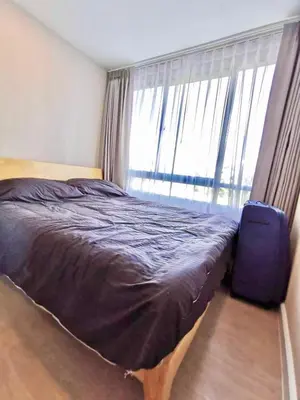 a bedroom with a bed and a large window at rama9\u533a\u57df\u5730\u94c1\u8c6a\u534e\u516c\u5bd3\u51fa\u79df Metro Luxe Ratchada in Bangkok