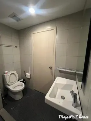 a bathroom with a toilet and a sink at Z house Sukhumvit in Bangkok