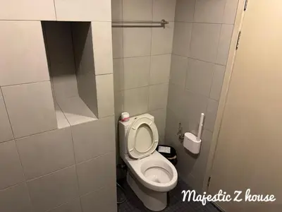 a small bathroom with a toilet in a stall at Z house Sukhumvit in Bangkok