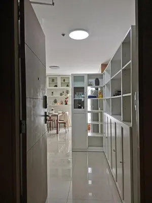 a hallway with white cabinets and a dining room at PERFECT 80sqm apartment serve up to 5 \u5b8c\u7f8e\u7684\u516c\u5bd3 in Bangkok