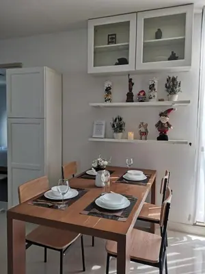 a dining room with a wooden table and chairs at PERFECT 80sqm apartment serve up to 5 \u5b8c\u7f8e\u7684\u516c\u5bd3 in Bangkok