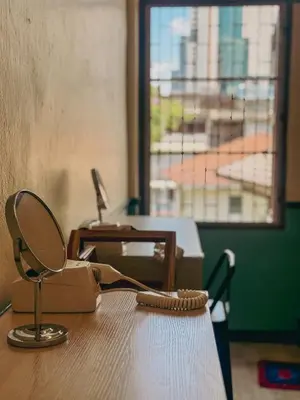 a purse sitting on top of a table with a window at During Moonshine Stay in Bangkok
