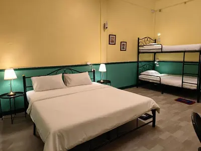 a bedroom with a bed and two bunk beds at During Moonshine Stay in Bangkok