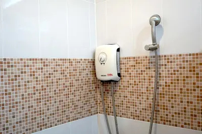 a shower with a soap dispenser in a bathroom at Family Friendly Home in Bangna