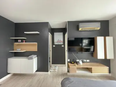 a bedroom with black walls and a bed and a desk at Studio123 at changwattana in Ban Bang Phang