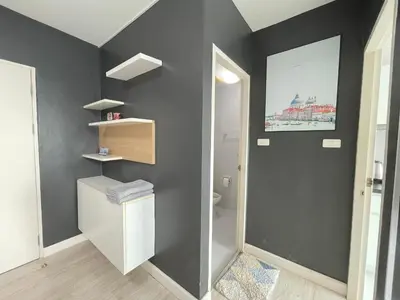 a bathroom with a gray wall and a toilet at Studio123 at changwattana in Ban Bang Phang