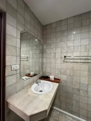 a bathroom with a sink and a mirror at Hotel Nanon Sathorn in Bangkok