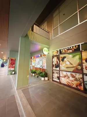 a store front with signs and plants in a building at 2BR - MRT Lak Song 5 Minute - Garden-Gym-Pool-wifi in Ban Khlong Khwang Klang