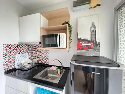 a small kitchen with a sink and a microwave at Studio71 at changwattana in Ban Bang Phang