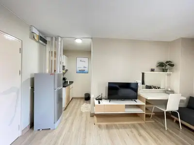a living room with a refrigerator and a desk at Studio16 at Changwattana in Ban Bang Phang