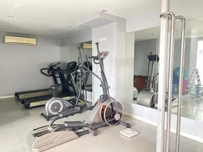 a gym with several exercise bikes and a mirror at Studio117 at Changwattana in Ban Bang Phang