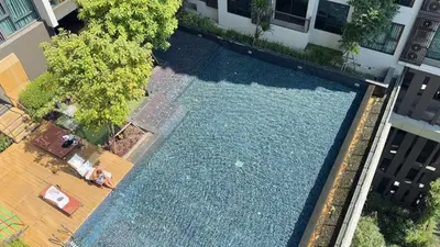 an overhead view of a swimming pool in front of a building at Luxurious Downtown Apartment With Train Access Bts in Bangkok