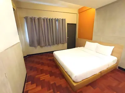 a white bed in a room with a window at XX GO INN Silom BTS Surasak - สุรศักดิ์ in Bangkok