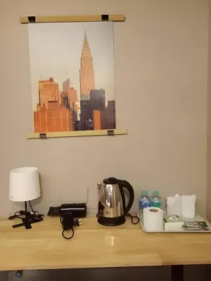 a table with a tea kettle and a lamp on it at XX GO INN Silom BTS Surasak - สุรศักดิ์ in Bangkok