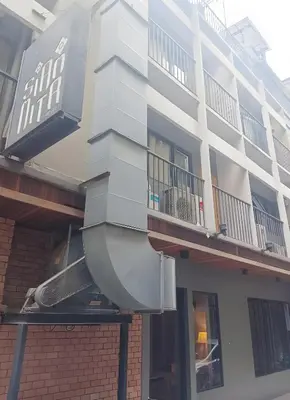 a white building with a balcony on the side of it at XX GO INN Silom BTS Surasak - สุรศักดิ์ in Bangkok