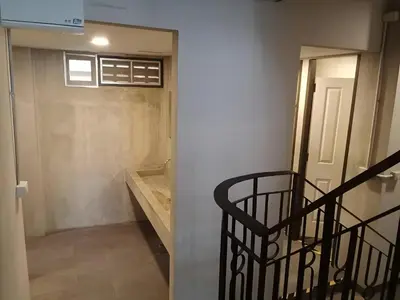 a room with a staircase and a door with a window at XX GO INN Silom BTS Surasak - สุรศักดิ์ in Bangkok