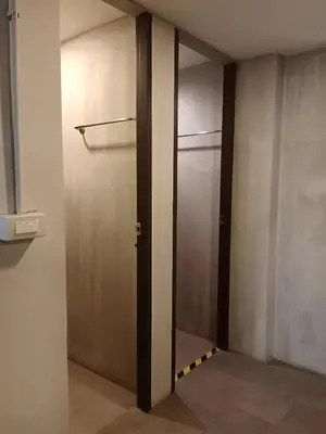 a hallway with a door in a room at XX GO INN Silom BTS Surasak - สุรศักดิ์ in Bangkok