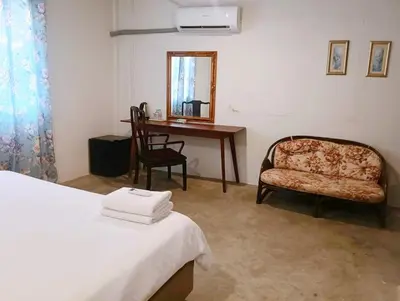 a bedroom with a bed and a desk and a chair at XX Mitr Inn Yaowarat China town -มิตร อินน์ เยาวราช in Bangkok