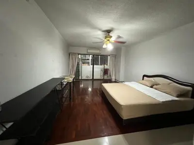 a bedroom with a bed and a ceiling fan at Srivara condo Rachada in Bangkok