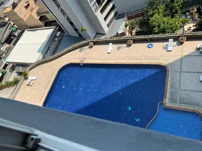 an overhead view of a large blue swimming pool at Srivara condo Rachada in Bangkok
