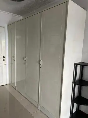 a large glass wall in a room with a stool at Srivara condo Rachada in Bangkok