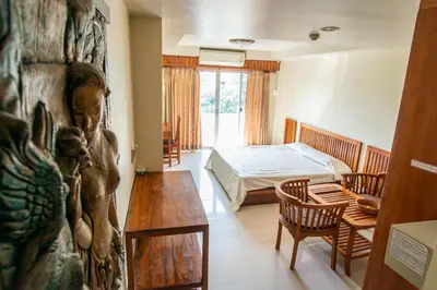 a bedroom with a bed and a table in a room at Sathorn View in Bangkok