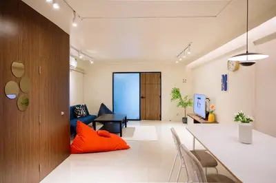 an office lobby with orange pillows on the floor at Liver Bird Ratchada in Bangkok