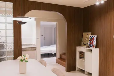 a dining room with a table and a mirror at Liver Bird Ratchada in Bangkok