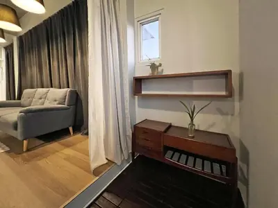 a living room with a couch and a table at Human Touch Room - Soulful Bangkok Hideout in Lat Krabang