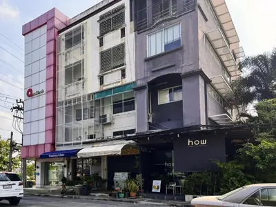 a tall building with a hulu store on a street at Human Touch Room - Soulful Bangkok Hideout in Lat Krabang
