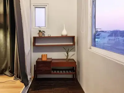 a room with a table next to a window at Human Touch Room - Soulful Bangkok Hideout in Lat Krabang